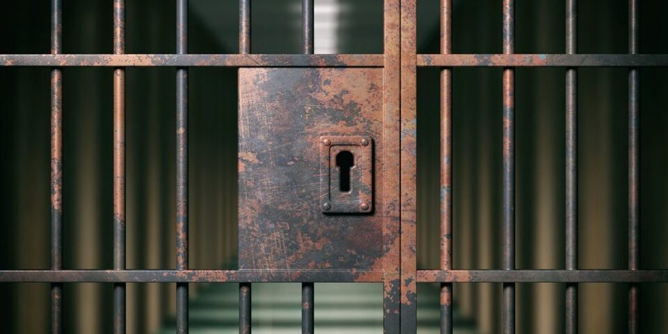 prison-interior-locked-rusty-door-closeup-dark-PWJ8HSY-min