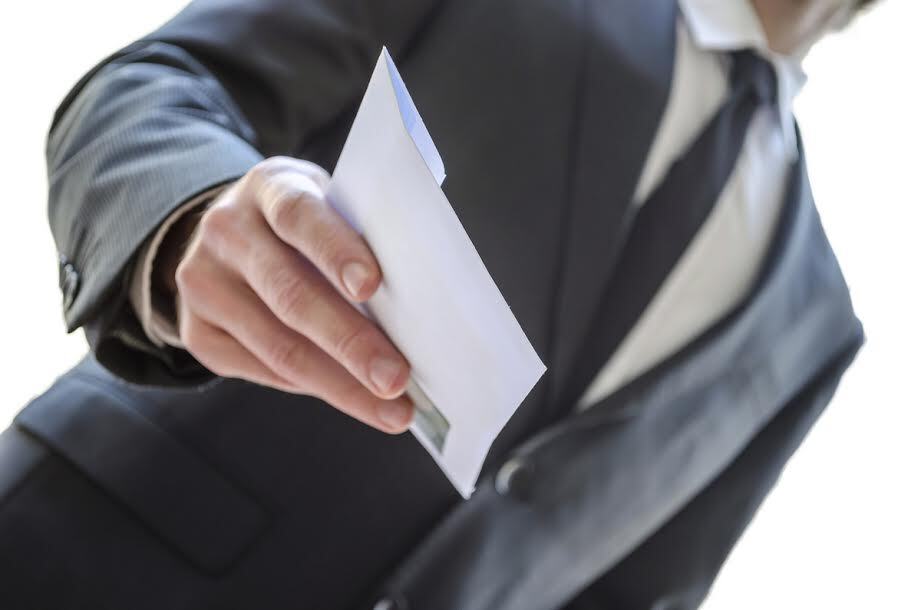 Cropped view of a man giving envelope. With white background.